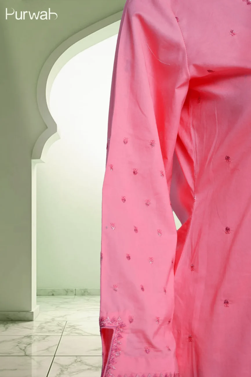 A close-up view of the pink kurta's embroidered sleeve with intricate floral patterns, highlighting the delicate work.