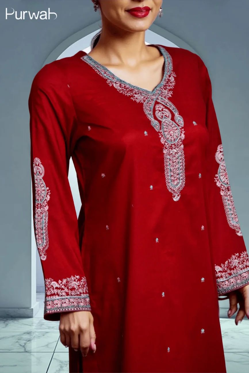 A closer shot of the red kurta, highlighting the exquisite embroidery on the sleeves and neckline.