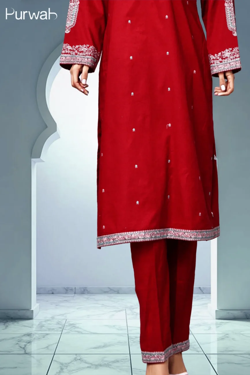 A model showcasing a beautiful red outfit with intricate silver embroidery, featuring a long kurta paired with matching pants.