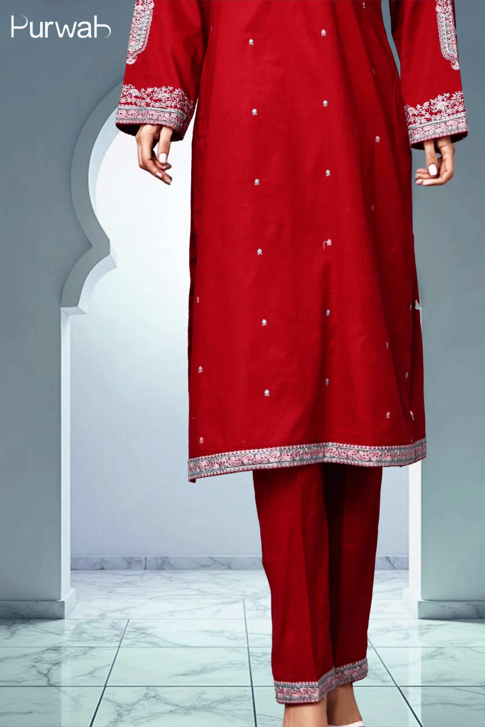 A model showcasing a beautiful red outfit with intricate silver embroidery, featuring a long kurta paired with matching pants.