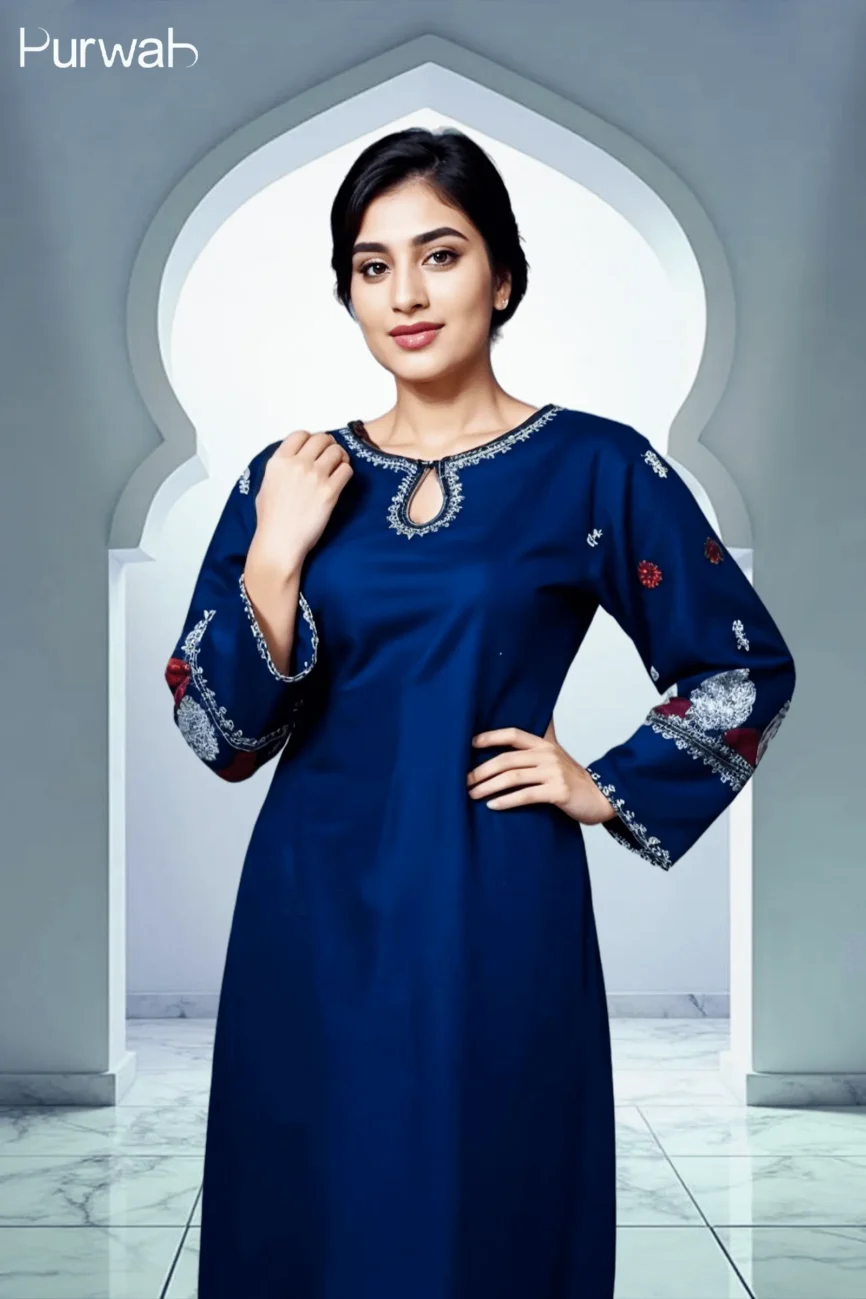 A model wearing a royal blue dress with intricate embroidery on the sleeves, standing confidently with her hand on her hip in front of an archway.