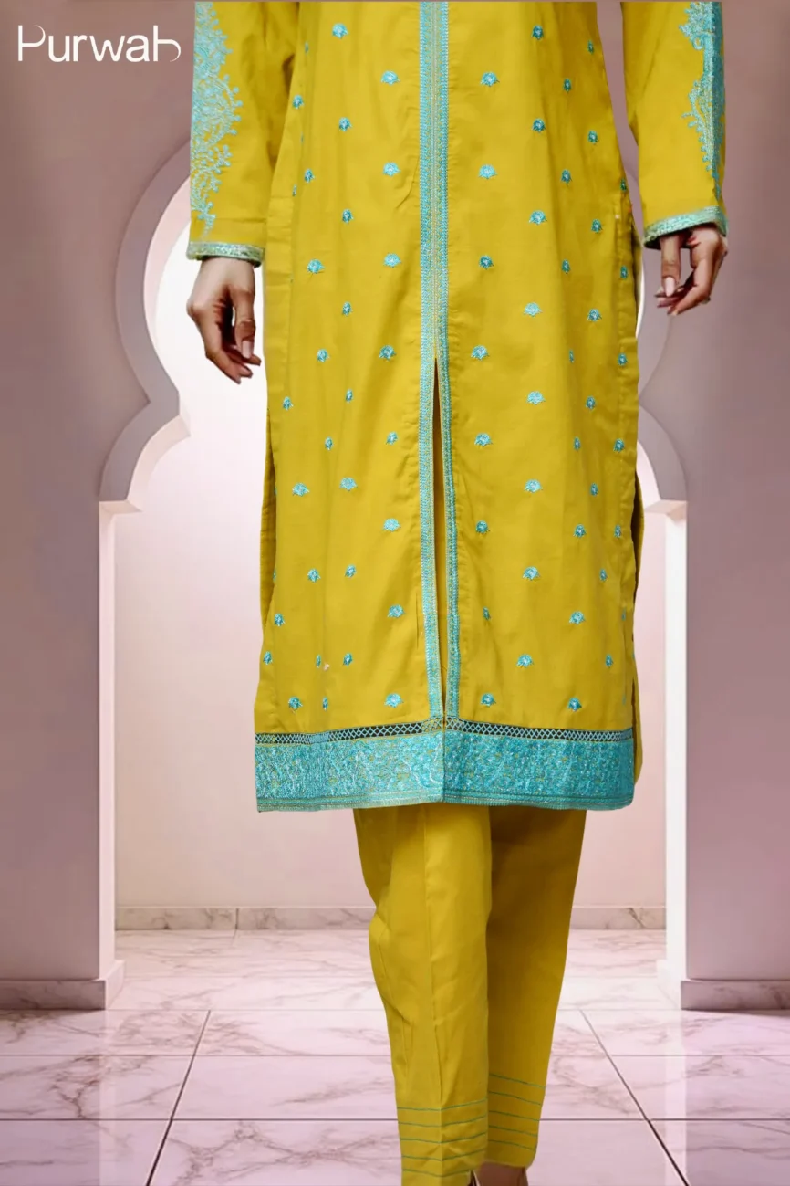 Close-up of the mustard yellow kurta with intricate turquoise embroidery, paired with matching yellow pants.