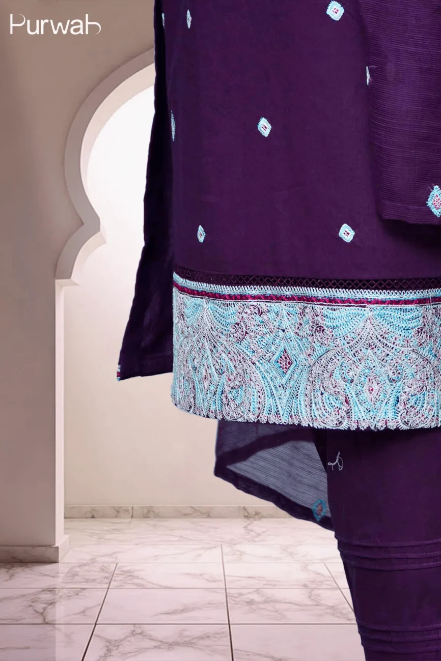 Close-up shot of a purple embroidered outfit showcasing intricate blue and red threadwork on the hem.