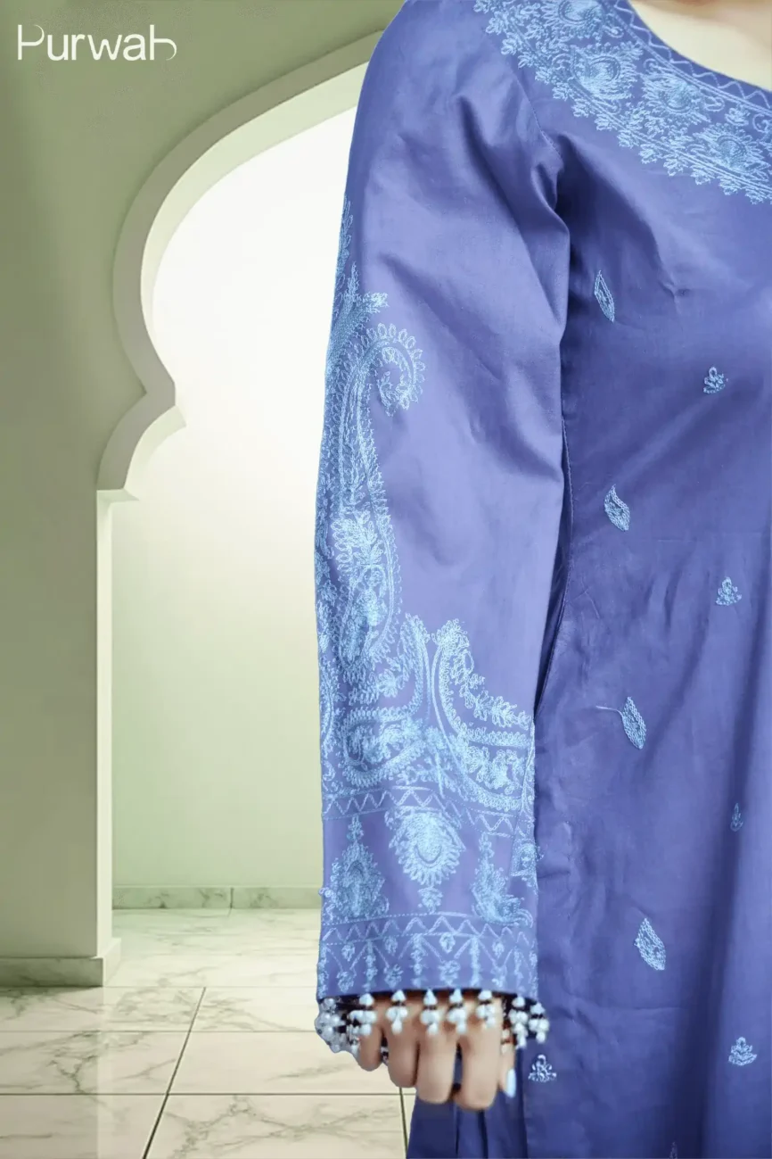 Close-up shot of the purple kurta's sleeve, showcasing delicate blue embroidery at the cuff with small decorative pearls.