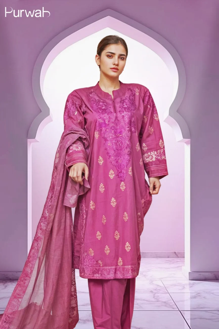 Elegant magenta embroidered dress with gold floral patterns, featuring intricate lace detailing on the sleeves and neckline, paired with a pearl necklace.