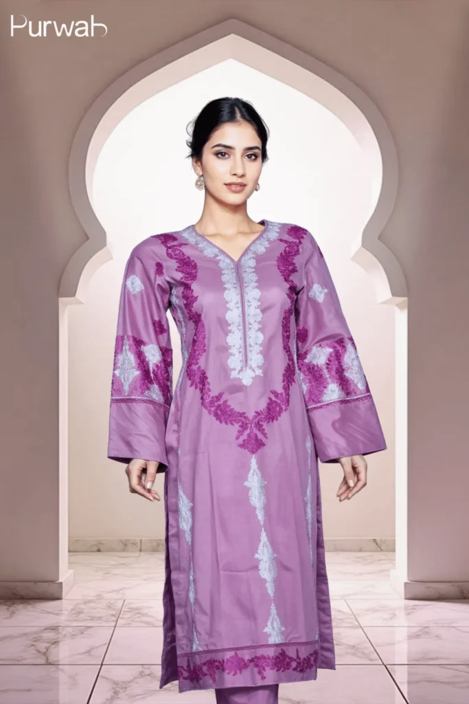 Full-body shot of a model wearing a purple dress with silver floral embroidery, highlighting the V-neck and long sleeves, with a soft and elegant background.