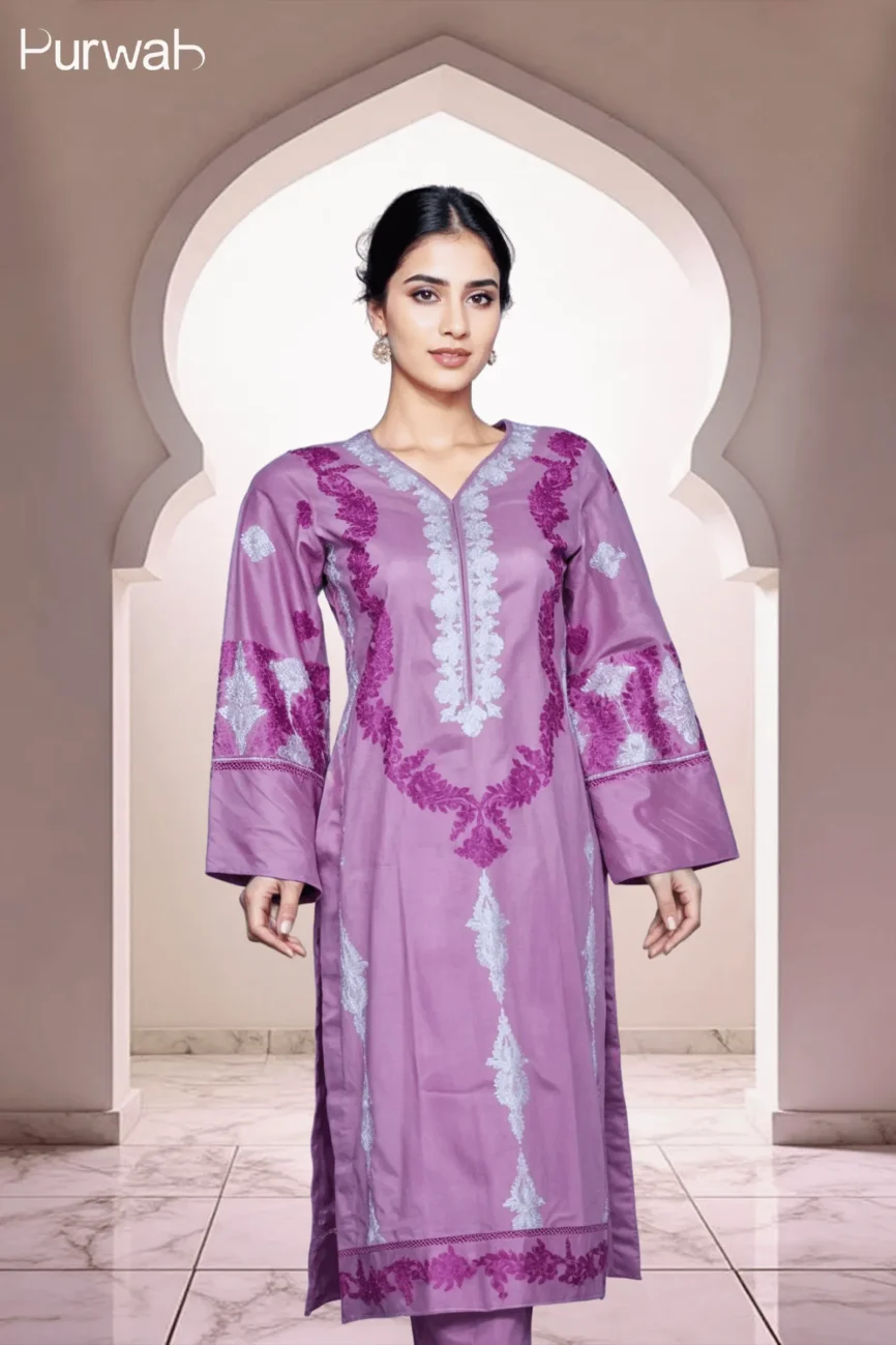 Full-body shot of a model wearing a purple dress with silver floral embroidery, highlighting the V-neck and long sleeves, with a soft and elegant background.