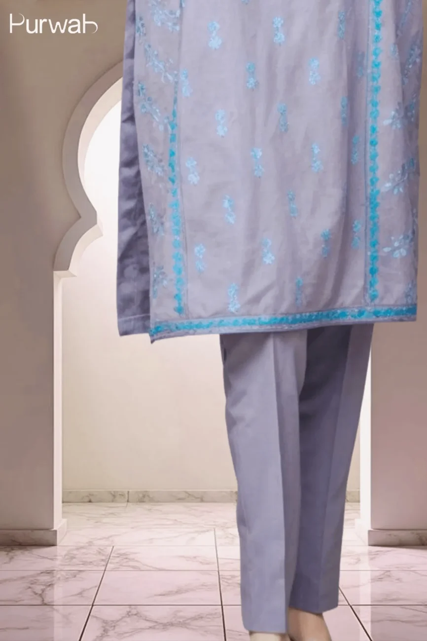 Full-length shot of the grey dress with turquoise floral embroidery, showing the dress and matching pants with a minimal background.