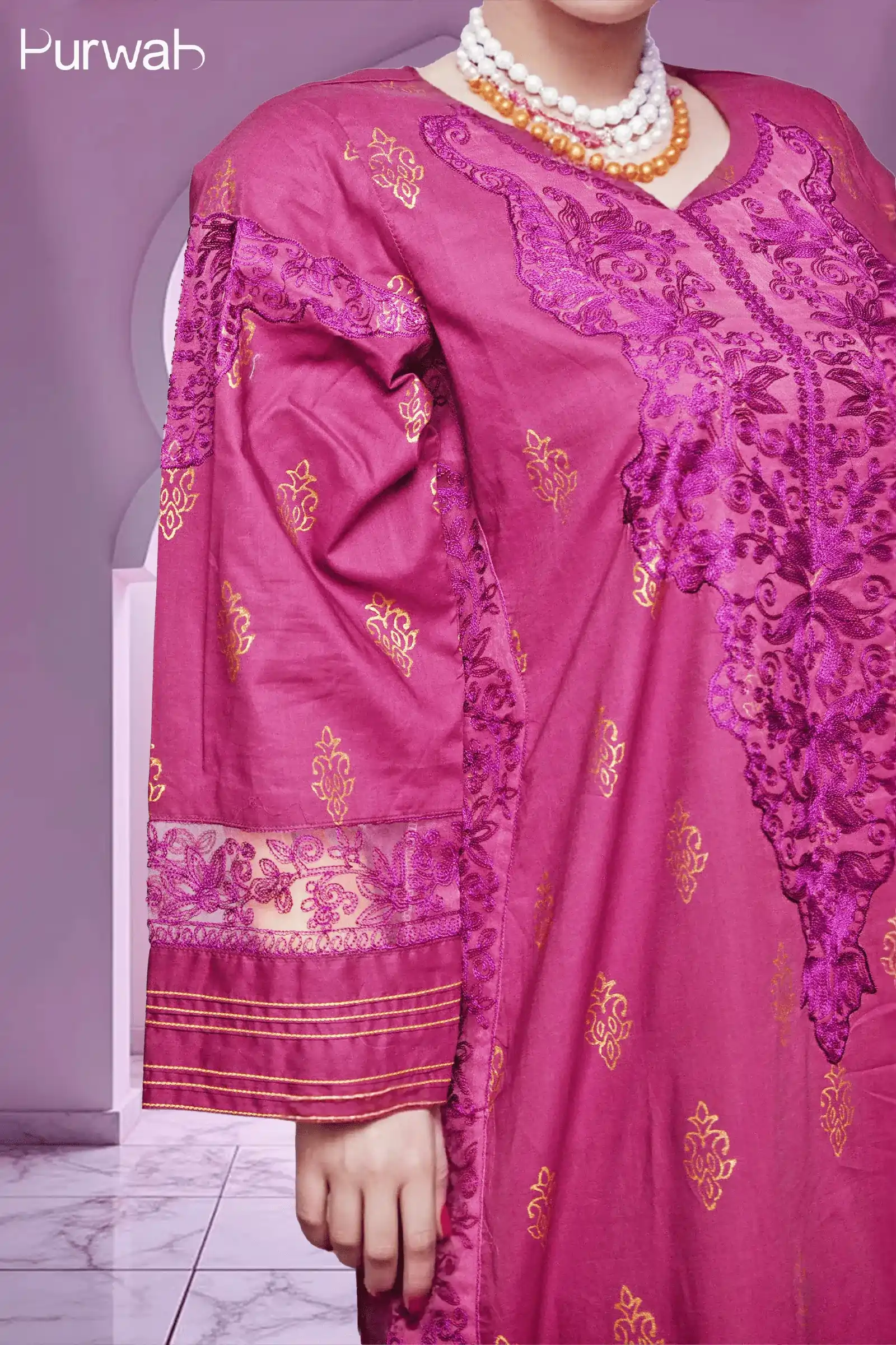 Magenta embroidered dress with gold floral designs, styled with a matching magenta veil and choker necklace, highlighting the luxurious look.