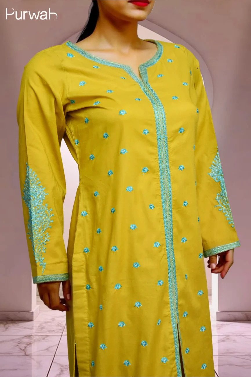 Side view of the mustard yellow kurta with detailed turquoise embroidery on the sleeves and neckline, worn by a model.